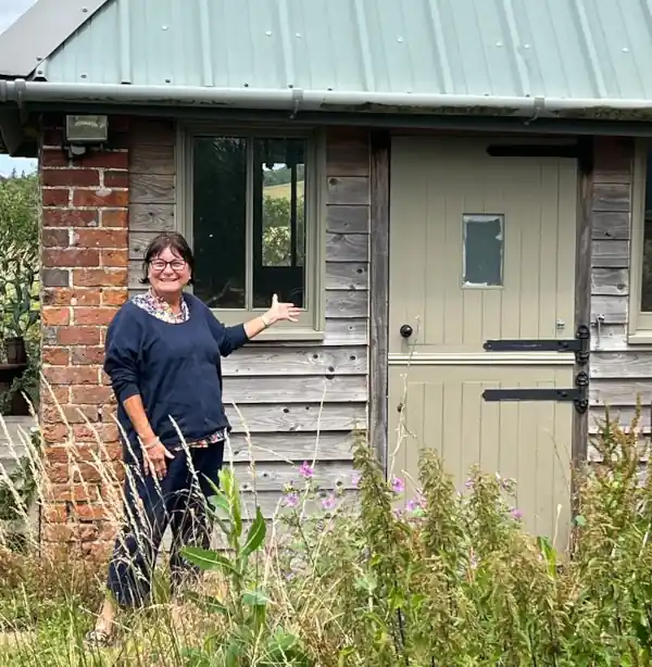 About to cross the threshold, a proud tenant of the rustic studio.